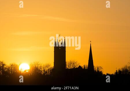 The tower of St. Mary`s Church and the spire of St. Nicholas Church at sunset, Warwick, Warwickshire, UK Stock Photo